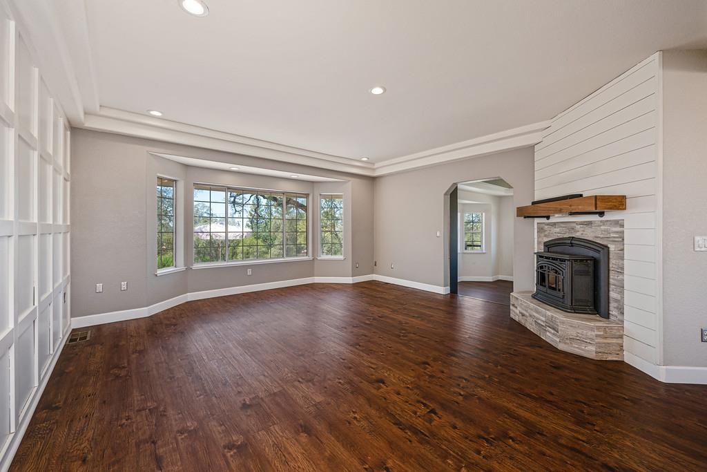 3154 Twin K Road Pilot Hill, CA 95664 - Photo 31 of 89 an empty room with wooden floor fireplace and windows