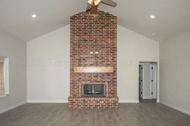 a view of an empty room and wooden floor