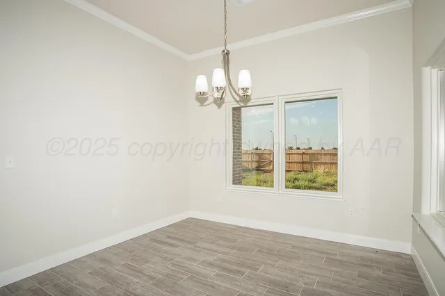 a view of a room with wooden floor and windows