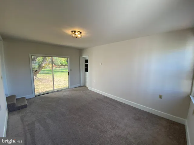 a view of a livingroom with a projector and a window