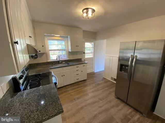 a kitchen with a refrigerator sink and stove