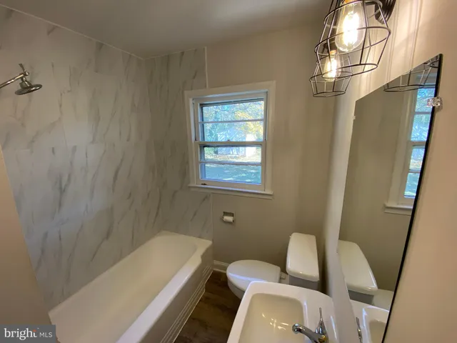 a bathroom with a tub and shower