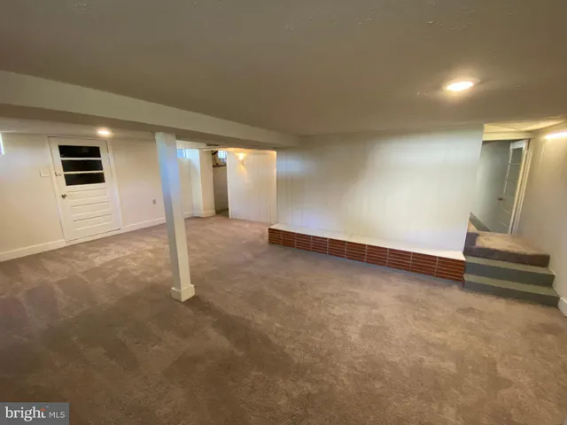 a view of an empty room with a fireplace