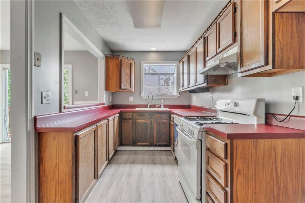 530 Griffin Street Pittsburgh, PA 15211 - Photo 11 of 41 a kitchen with stainless steel appliances granite countertop a stove and a sink