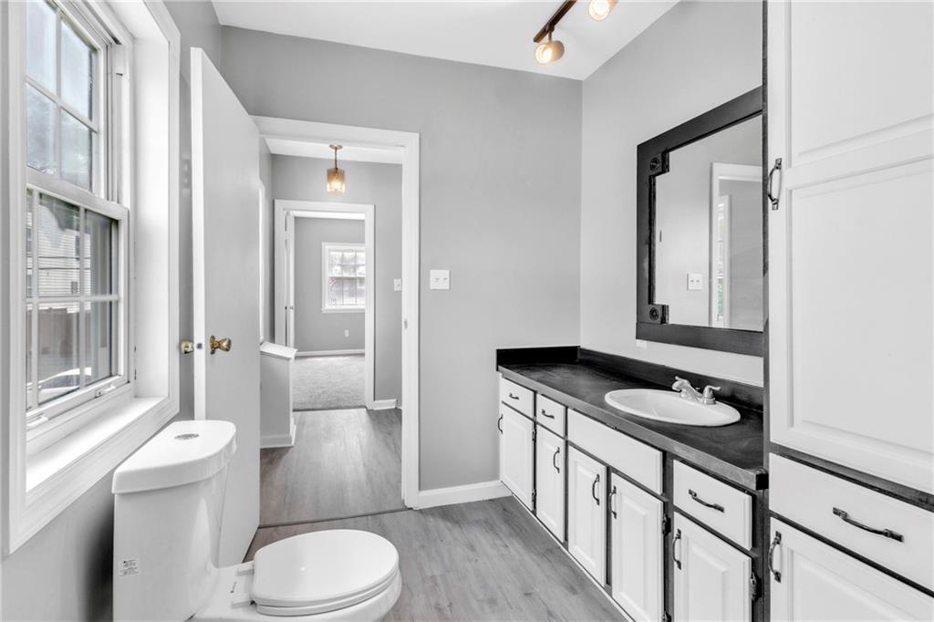 530 Griffin Street Pittsburgh, PA 15211 - Photo 15 of 41 a bathroom with a granite countertop toilet sink and mirror