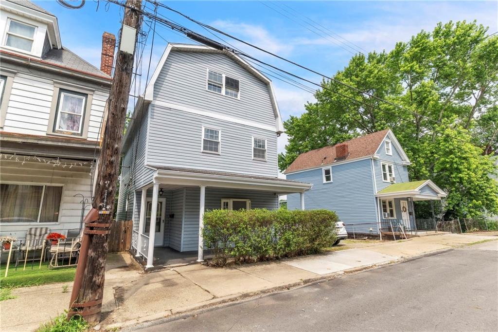 530 Griffin Street Pittsburgh, PA 15211 - Photo 3 of 41 a front view of a house with a yard and garage