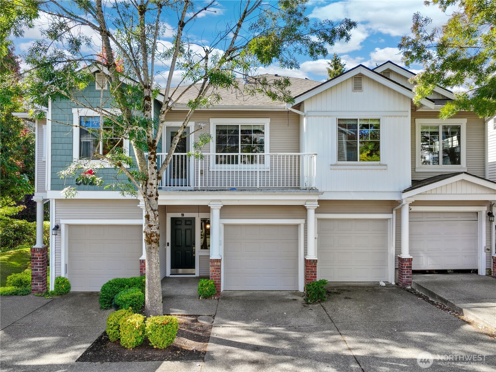 front view of a house with a yard and potted plants