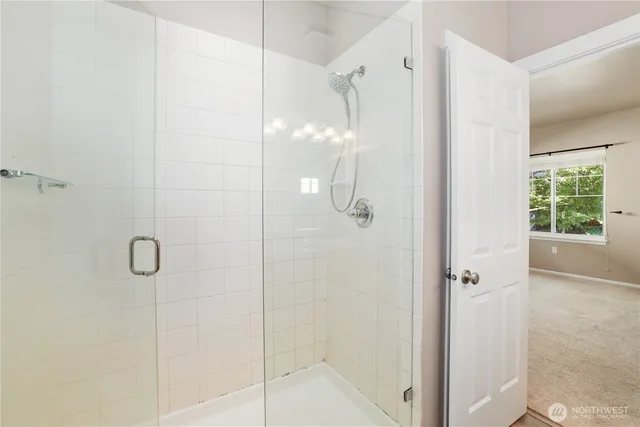 a bathroom with a glass shower door