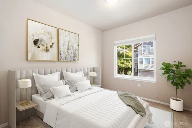 a bedroom with a bed and a painting on the wall