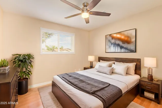 a bedroom with a bed and a potted plant