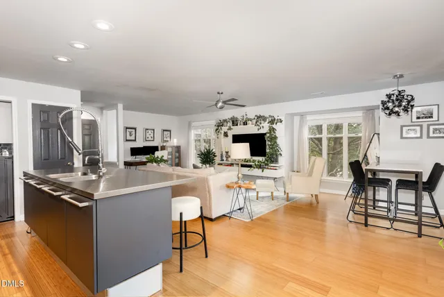 a living room with furniture a chandelier and a flat screen tv