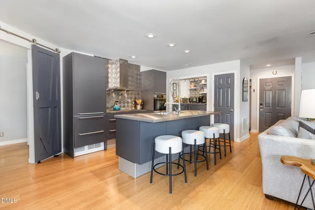 a living room with furniture and kitchen view
