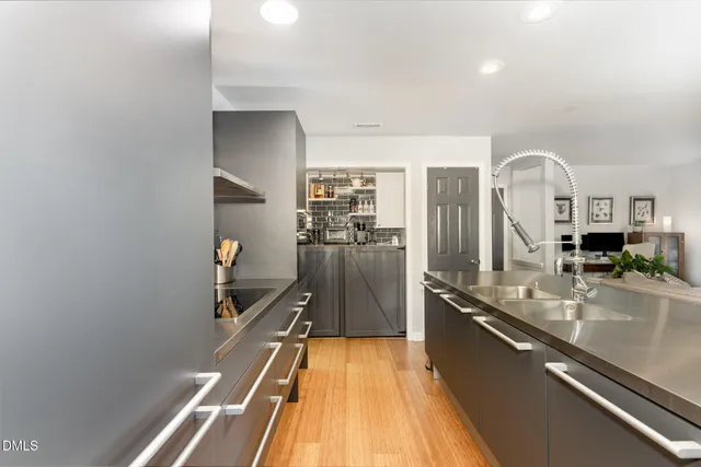 a kitchen with a table chairs refrigerator and cabinets