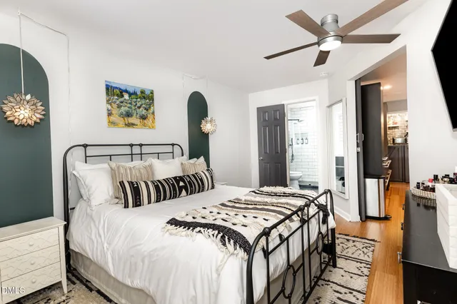 a view of a kitchen with kitchen island a counter top space a sink a stove and wooden floor