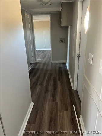 a view of a hallway and wooden floor