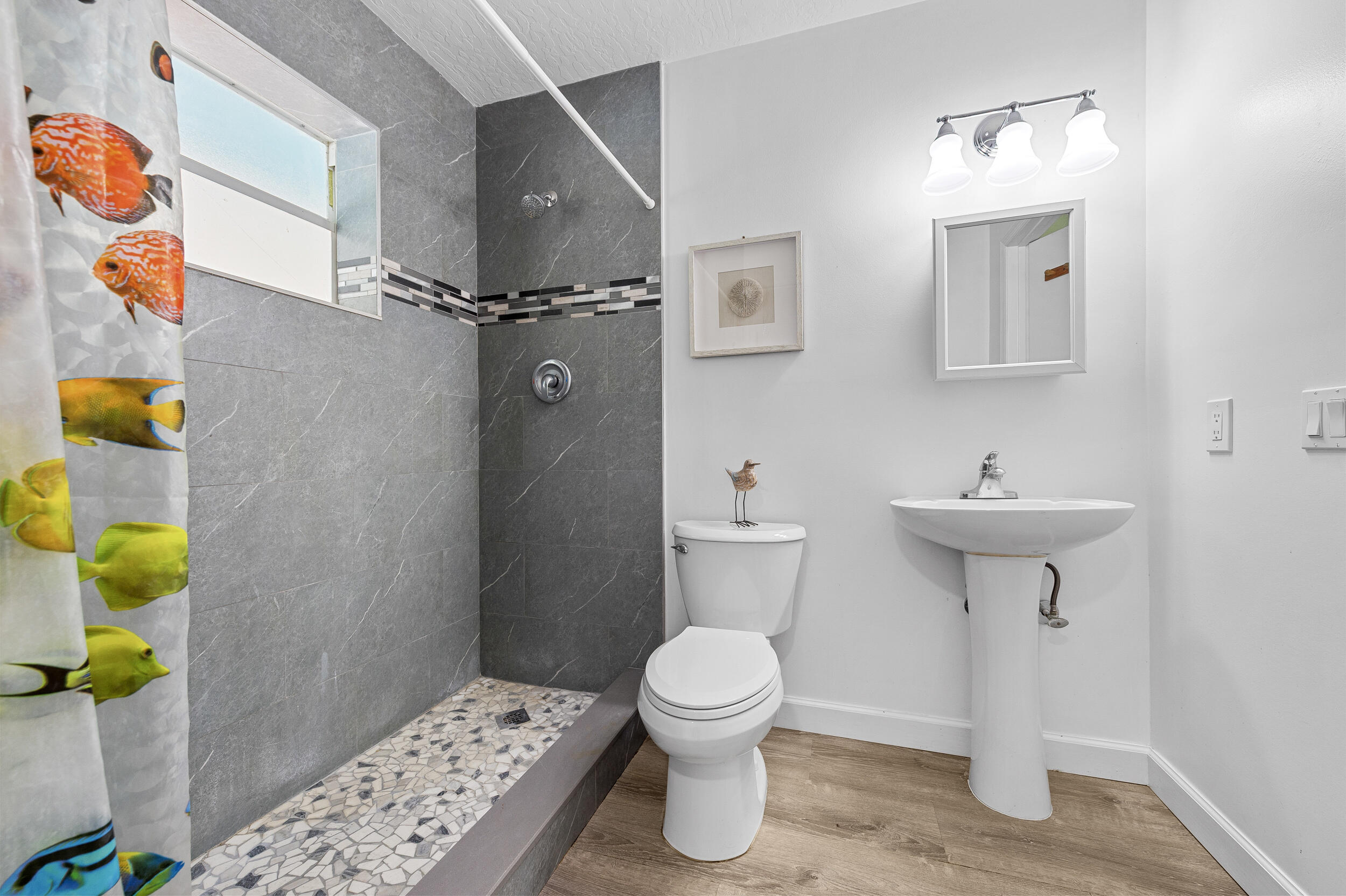 12450 77th Street Fellsmere, FL 32948 - Photo 11 of 44 a bathroom with a sink toilet and a mirror