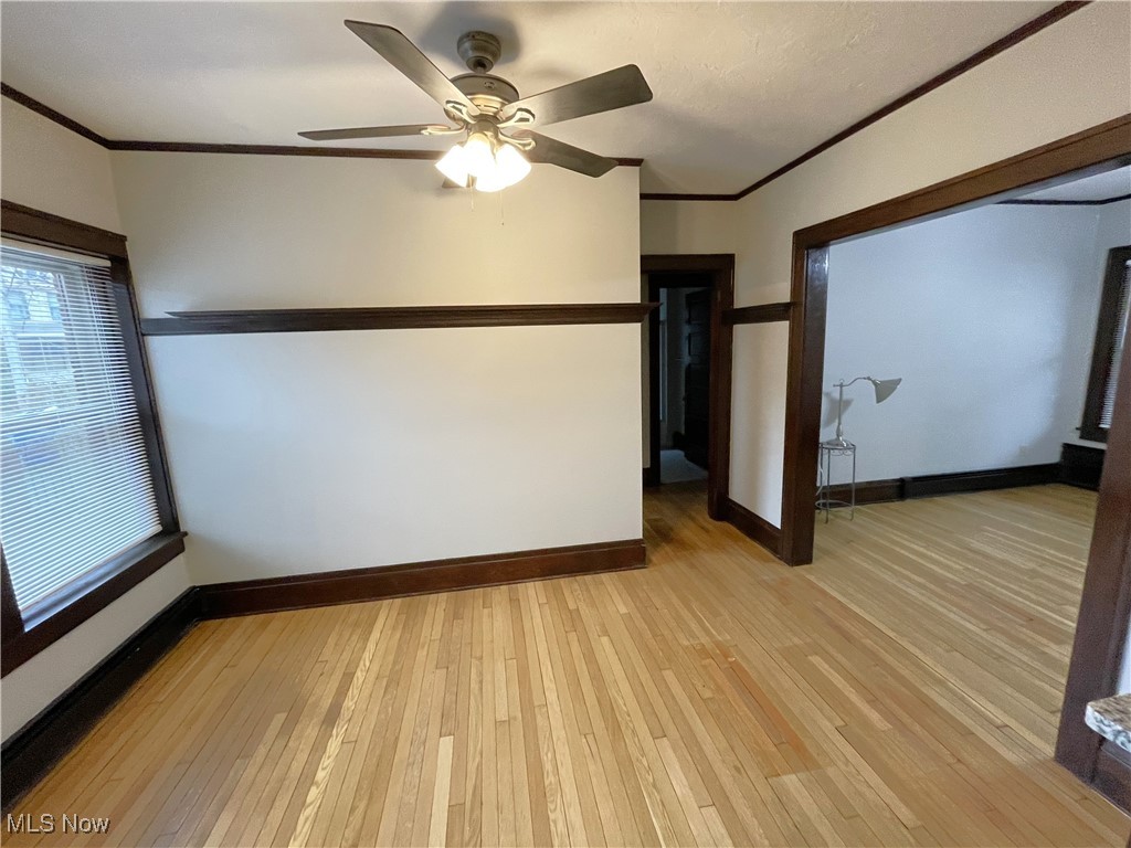 1905 Fulton Road, Unit 1B Cleveland, OH 44113 - Photo 5 of 22 Overlooks rear garden, refinished floors, natural woodwork, ceiling fan, plate rail