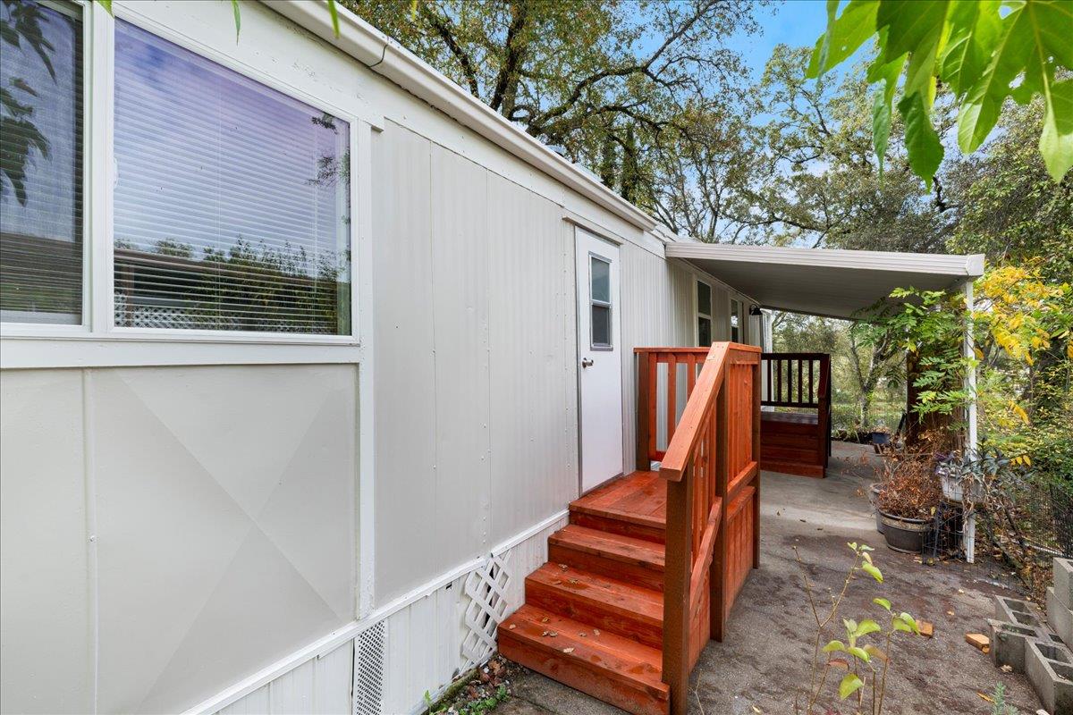 a backyard of a house with seating space and wooden fence