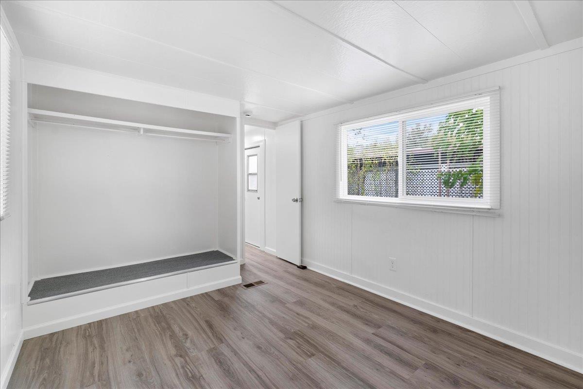1525 Cold Springs Road, Unit 82 Placerville, CA 95667 - Photo 12 of 20 an empty room with wooden floor and windows