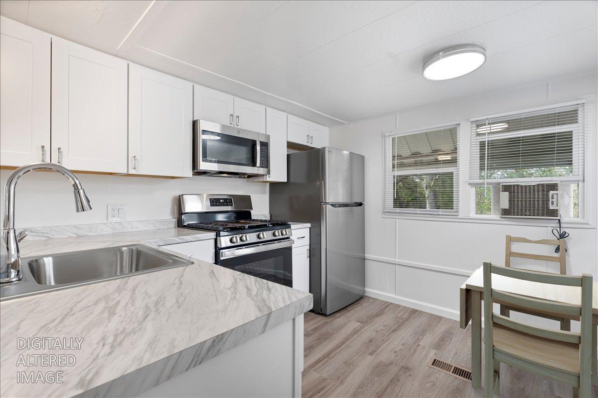 1525 Cold Springs Road, Unit 82 Placerville, CA 95667 - Photo 3 of 20 a kitchen with granite countertop a stove a sink and a refrigerator