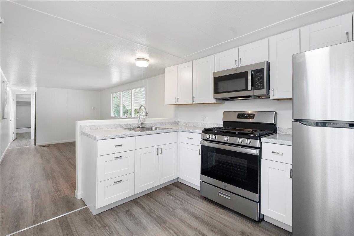 1525 Cold Springs Road, Unit 82 Placerville, CA 95667 - Photo 4 of 20 a kitchen with stainless steel appliances white cabinets a sink and a stove