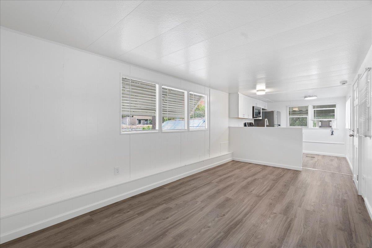 1525 Cold Springs Road, Unit 82 Placerville, CA 95667 - Photo 7 of 20 wooden floor in an empty room with a window