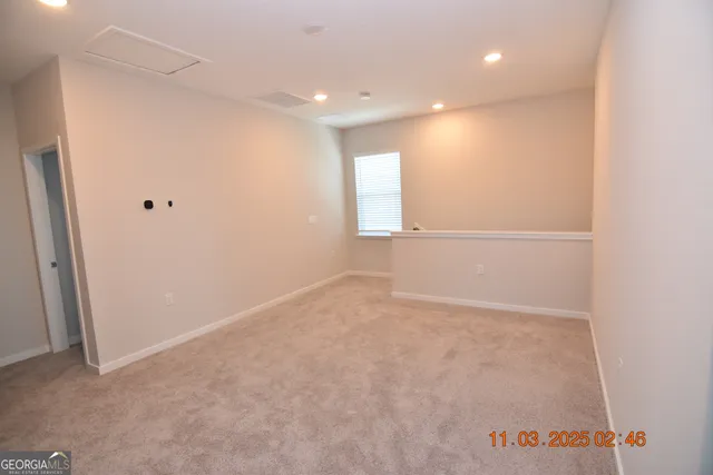 an empty room with a empty space and window