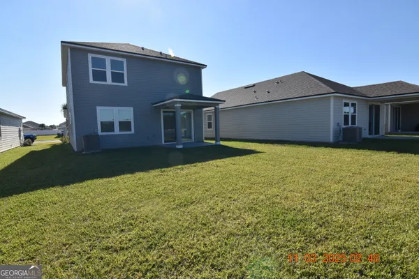 a view of a house with a yard