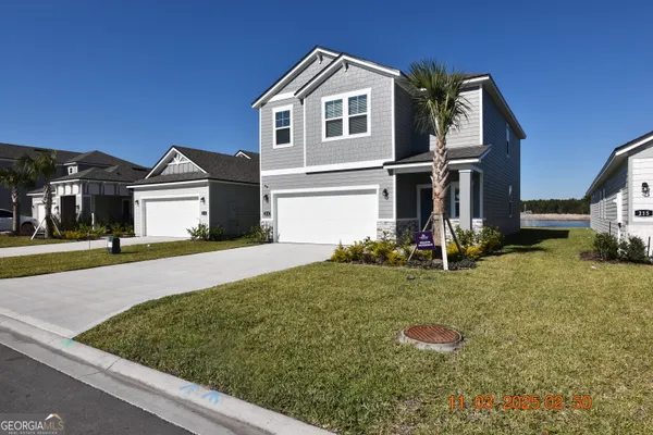 a front view of a house with garden