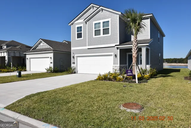 a front view of a house with garden