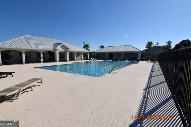 a front view of a house with yard and sitting area
