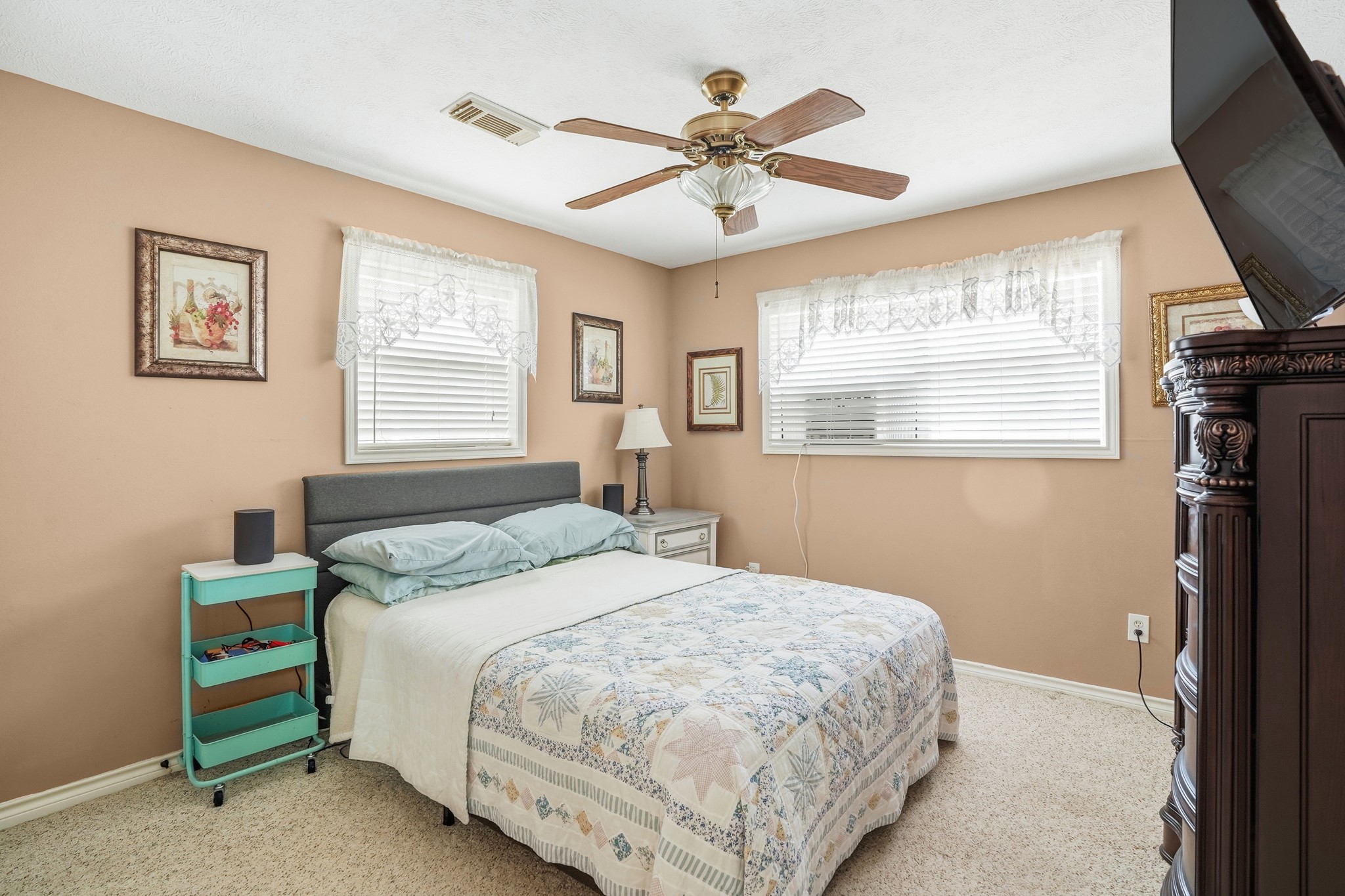 281 Broadmoor Street Trinity, TX 75862 - Photo 12 of 19 a bedroom with a bed next to a window and a flat screen tv