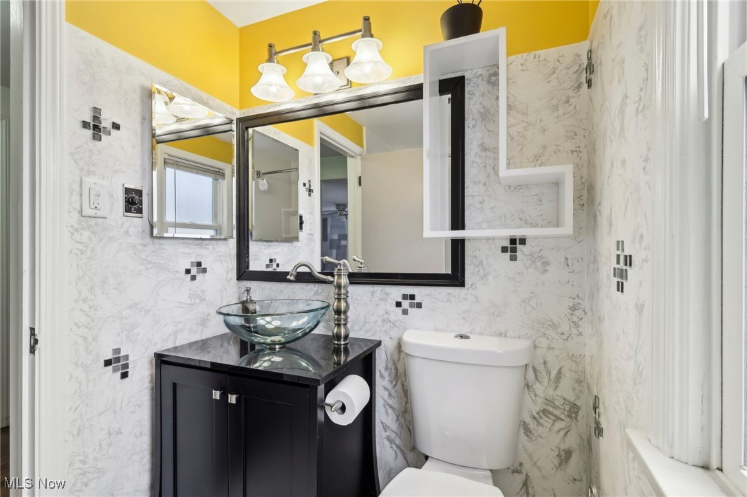 1311 Clearview Road Cleveland, OH 44124 - Photo 24 of 45 Bathroom with vanity, toilet, and tile walls