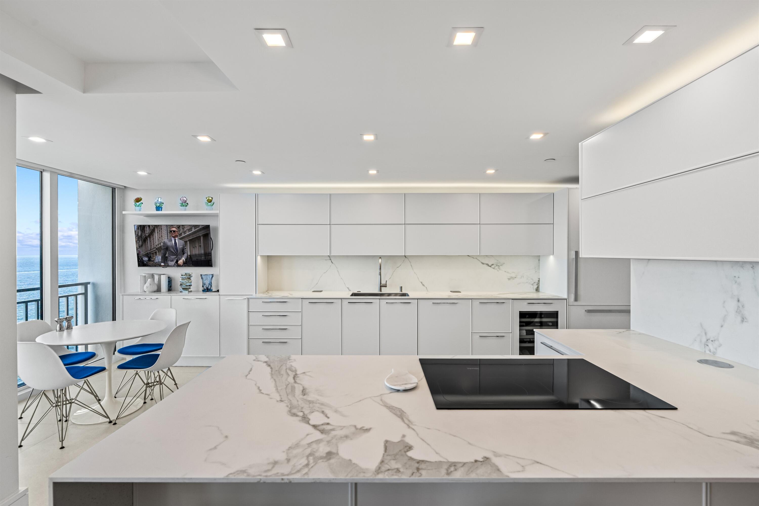 2600 South Ocean Boulevard, Unit 19E Boca Raton, FL 33432 - Photo 11 of 53 a kitchen with a sink stove and cabinets