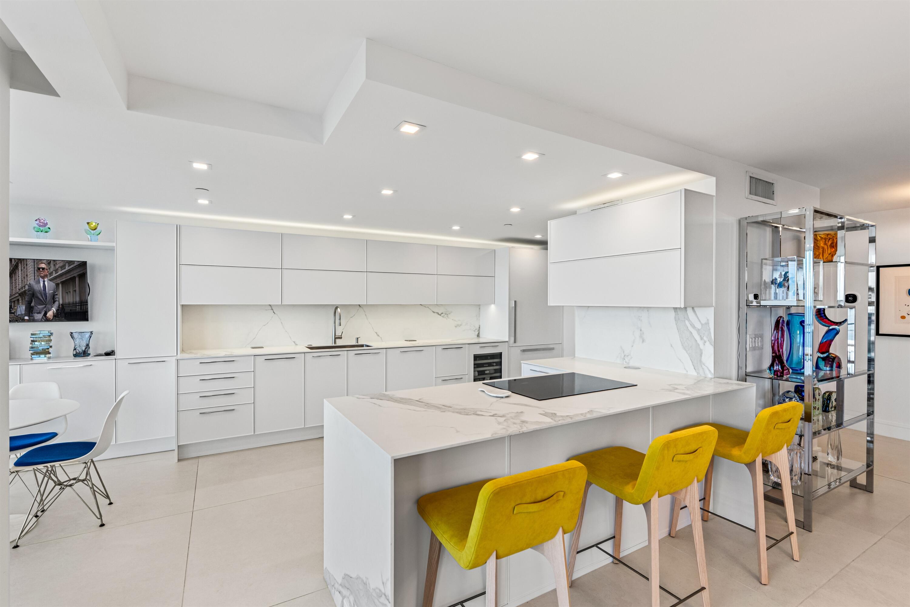 2600 South Ocean Boulevard, Unit 19E Boca Raton, FL 33432 - Photo 12 of 53 a kitchen that has a table and chairs in it