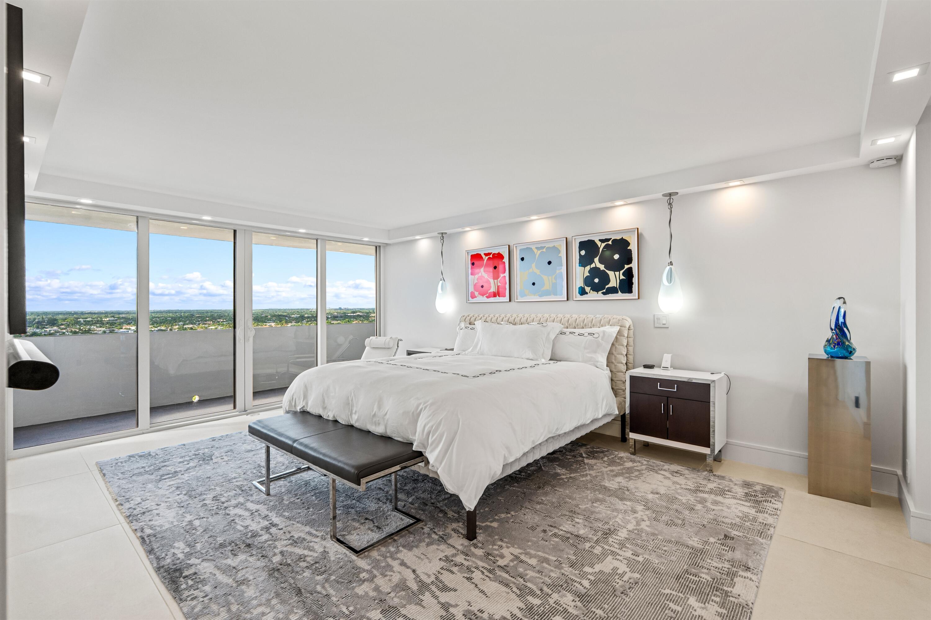 2600 South Ocean Boulevard, Unit 19E Boca Raton, FL 33432 - Photo 16 of 53 a bedroom with a bed and large window with balcony view