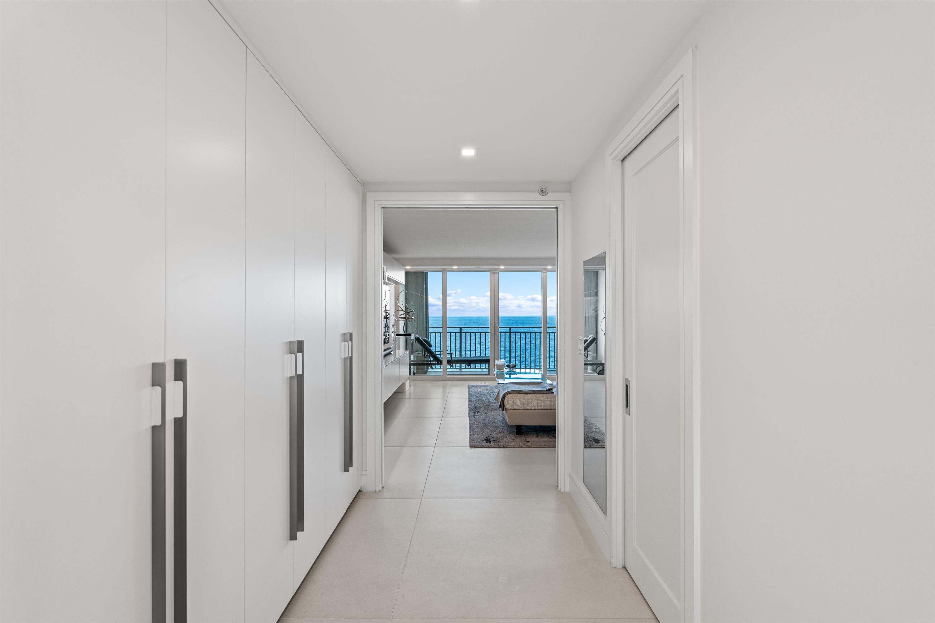 2600 South Ocean Boulevard, Unit 19E Boca Raton, FL 33432 - Photo 17 of 53 a hallway with white furniture and front door