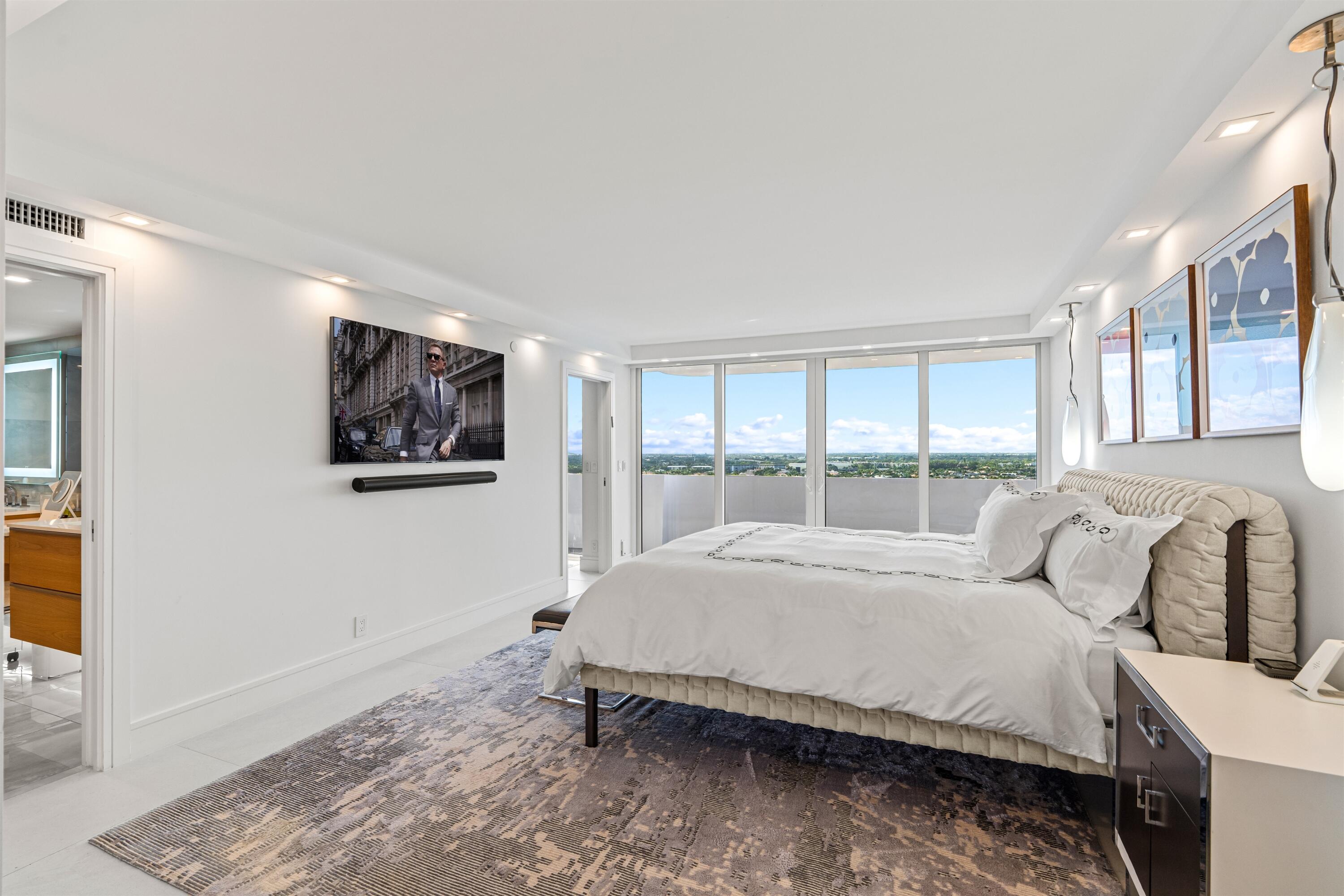 2600 South Ocean Boulevard, Unit 19E Boca Raton, FL 33432 - Photo 18 of 53 a spacious bedroom with a bed and a window
