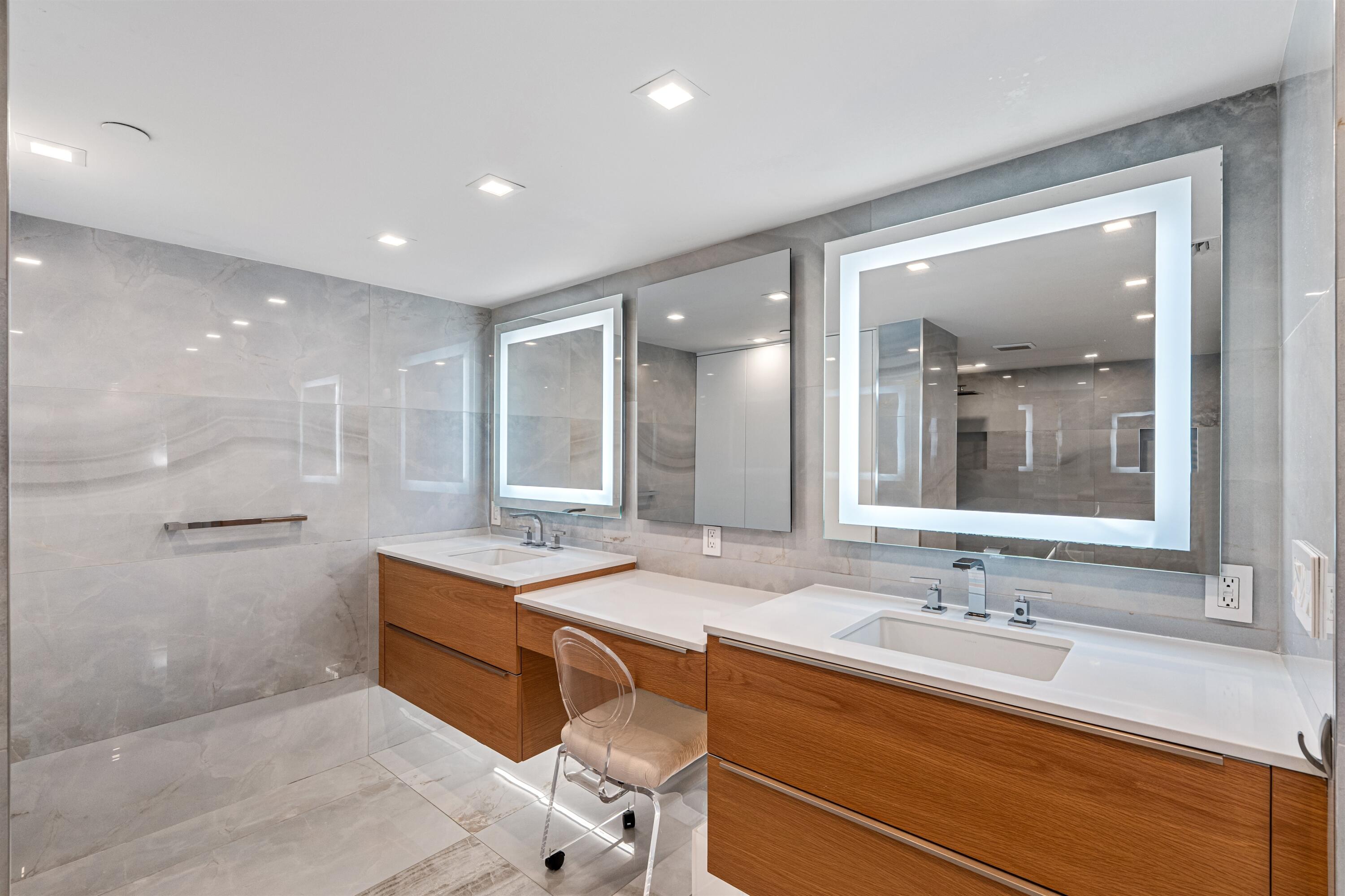 2600 South Ocean Boulevard, Unit 19E Boca Raton, FL 33432 - Photo 19 of 53 a bathroom with a sink double vanity and a mirror
