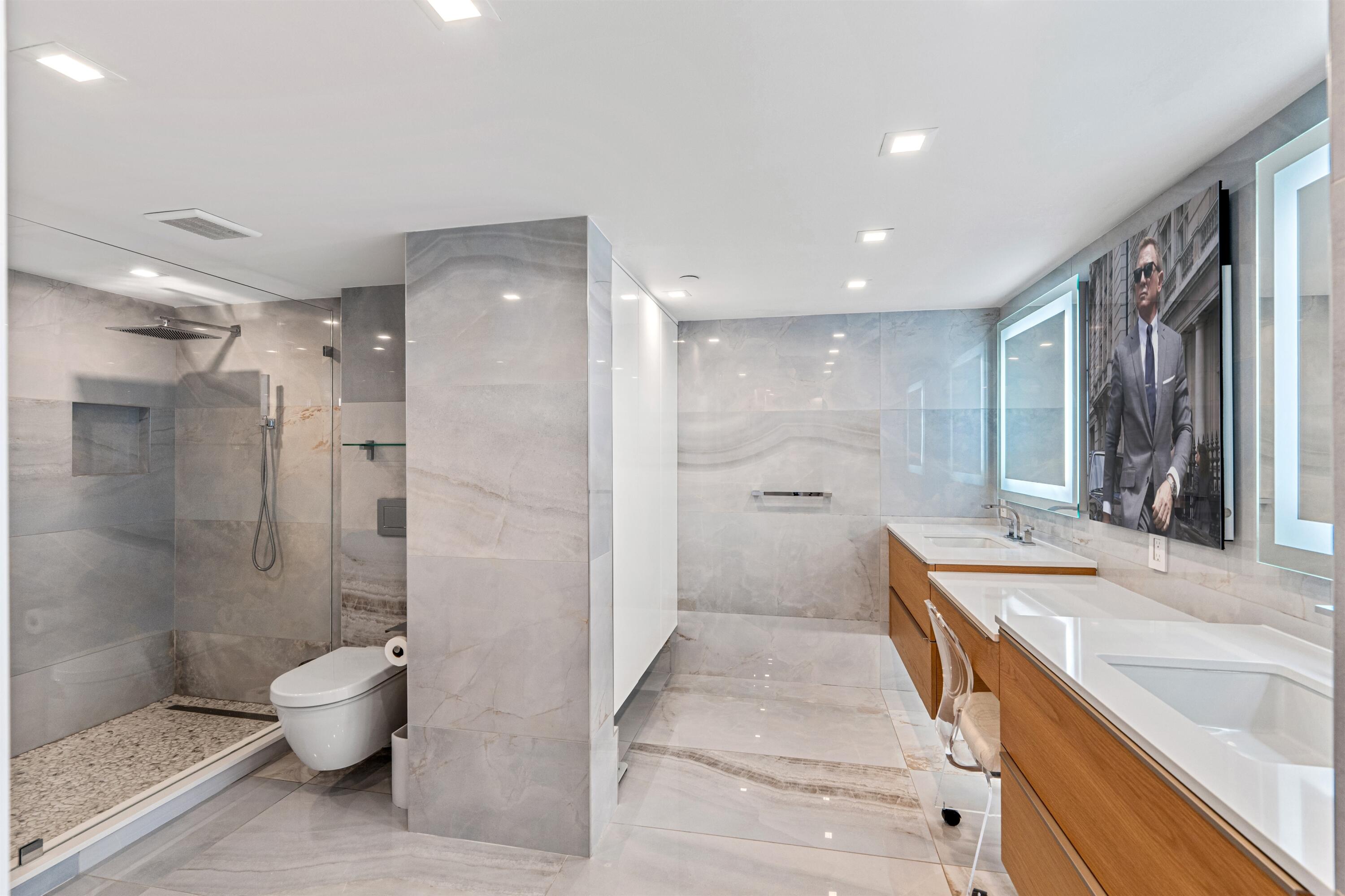 2600 South Ocean Boulevard, Unit 19E Boca Raton, FL 33432 - Photo 21 of 53 a bathroom with a granite countertop sink toilet and shower