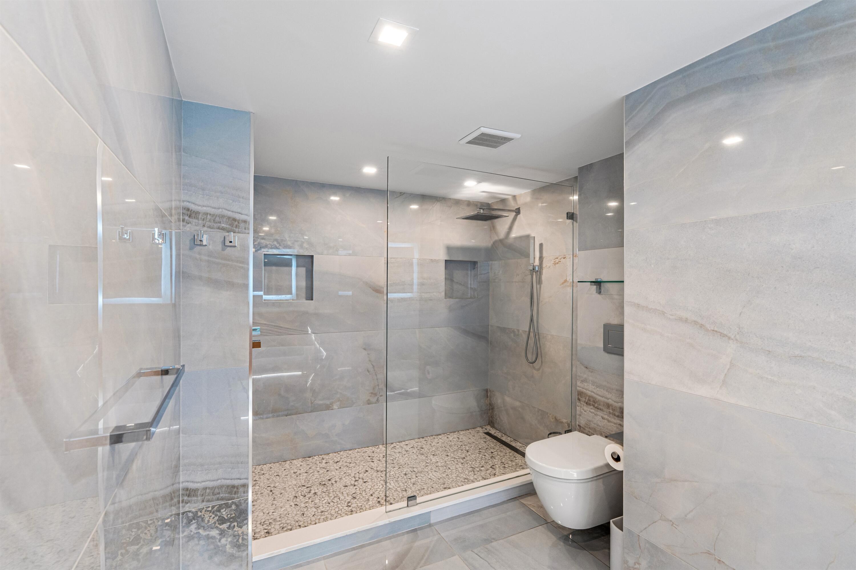 2600 South Ocean Boulevard, Unit 19E Boca Raton, FL 33432 - Photo 22 of 53 a bathroom with a shower and a toilet