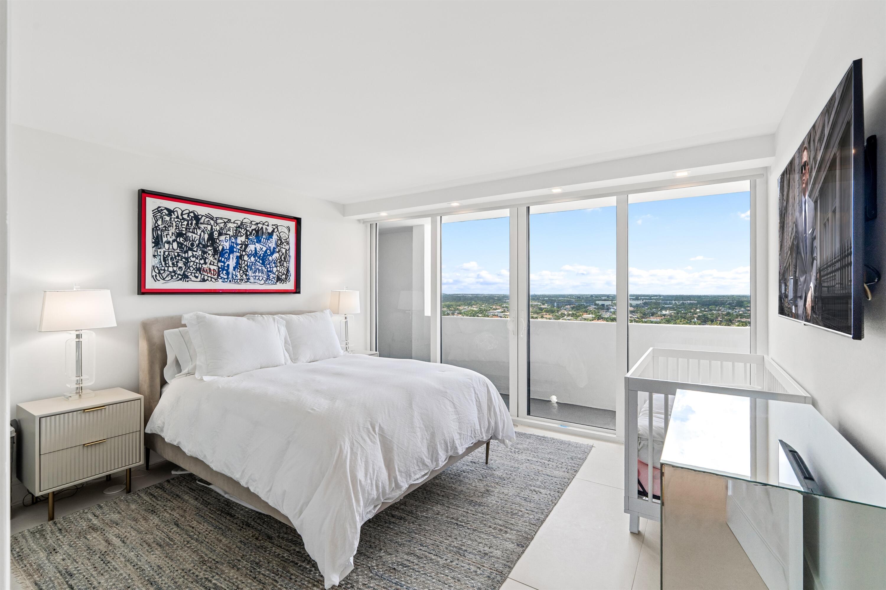 2600 South Ocean Boulevard, Unit 19E Boca Raton, FL 33432 - Photo 23 of 53 a bedroom with a large bed and a large window with outer view