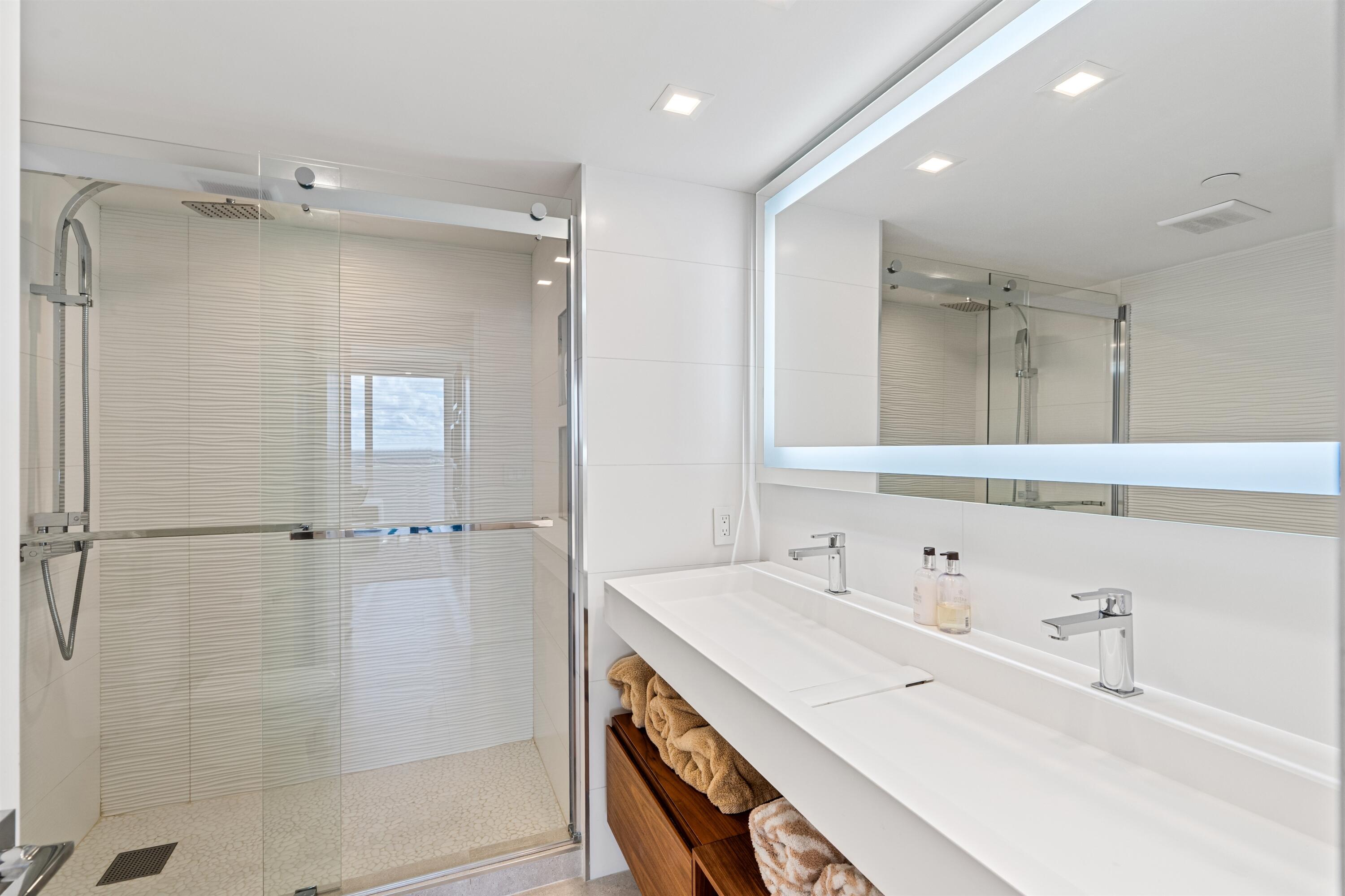2600 South Ocean Boulevard, Unit 19E Boca Raton, FL 33432 - Photo 24 of 53 a spacious bathroom with a shower sink and mirror