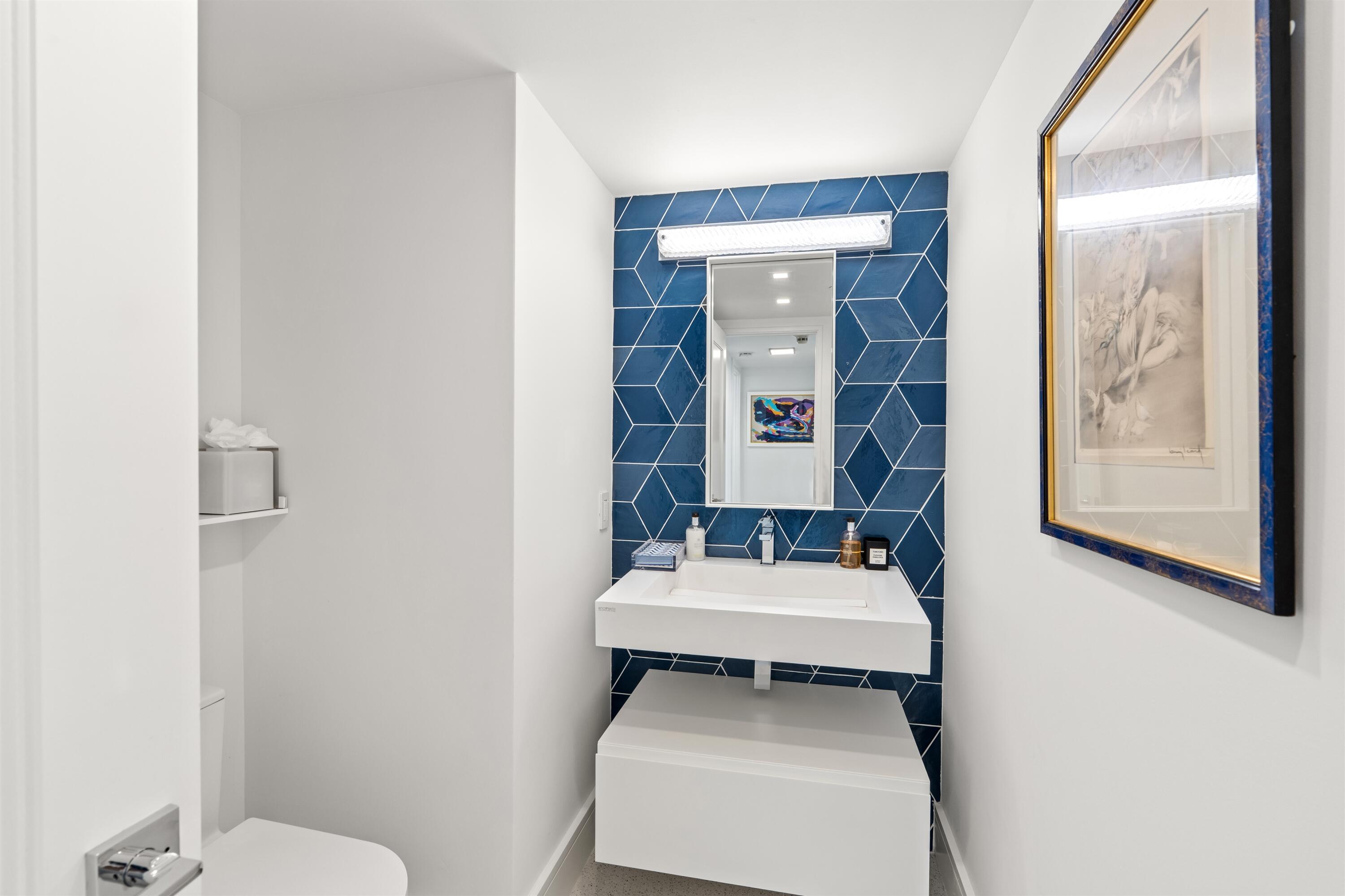 2600 South Ocean Boulevard, Unit 19E Boca Raton, FL 33432 - Photo 28 of 53 a bathroom with a sink toilet and mirror