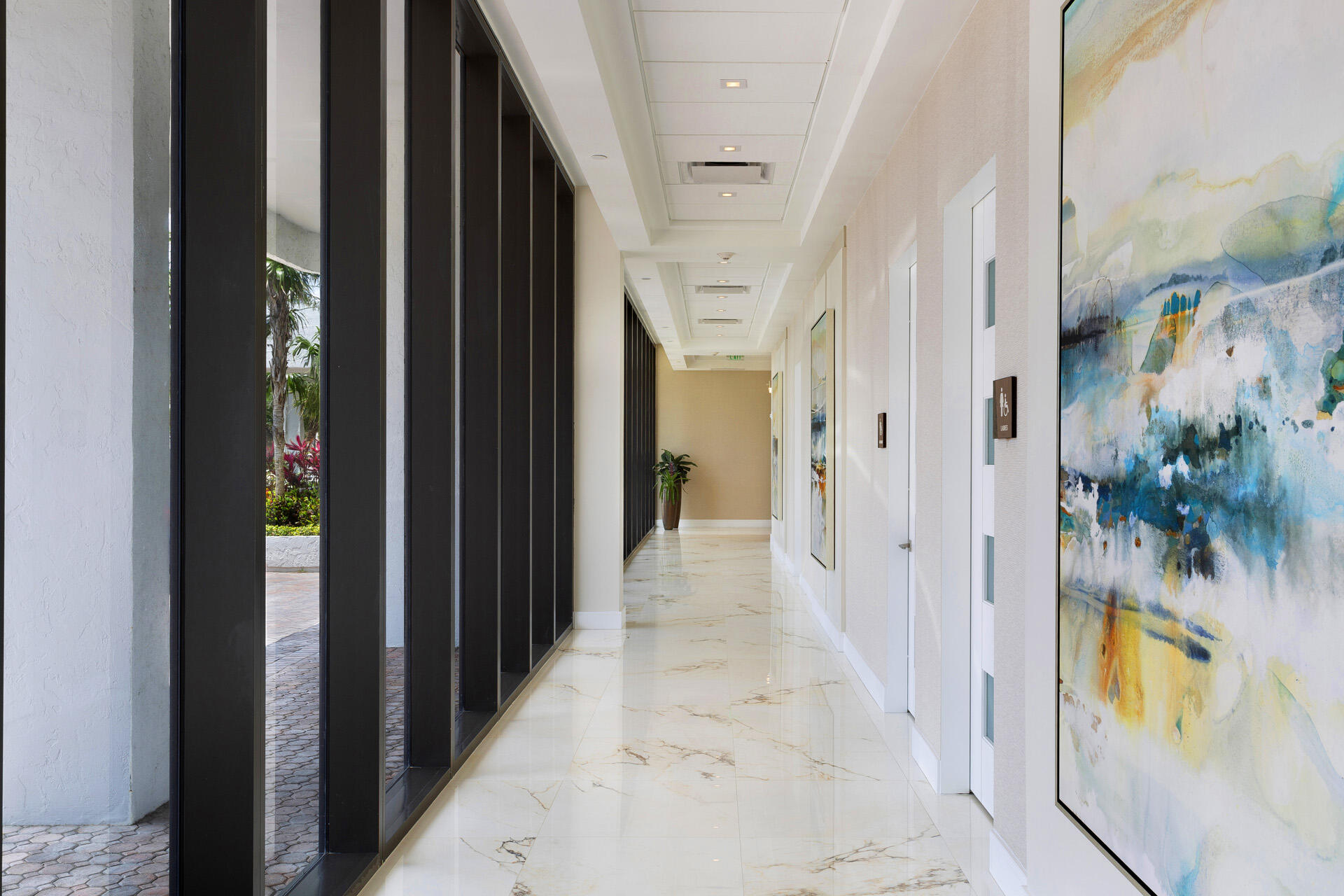 2600 South Ocean Boulevard, Unit 19E Boca Raton, FL 33432 - Photo 40 of 53 a view of a hallway with wooden floor and a potted plant