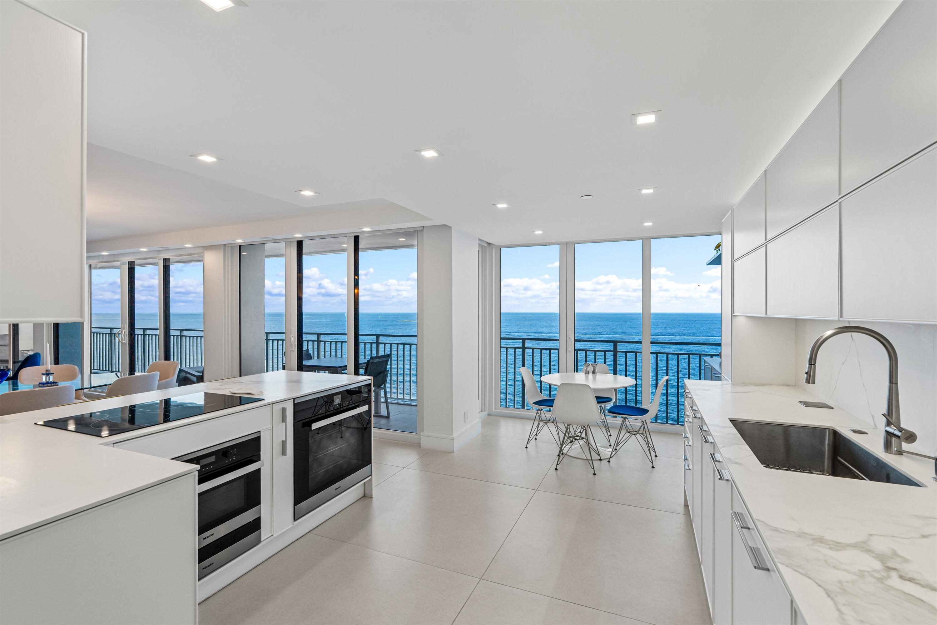 2600 South Ocean Boulevard, Unit 19E Boca Raton, FL 33432 - Photo 10 of 53 a large kitchen with a large window and a view of living room