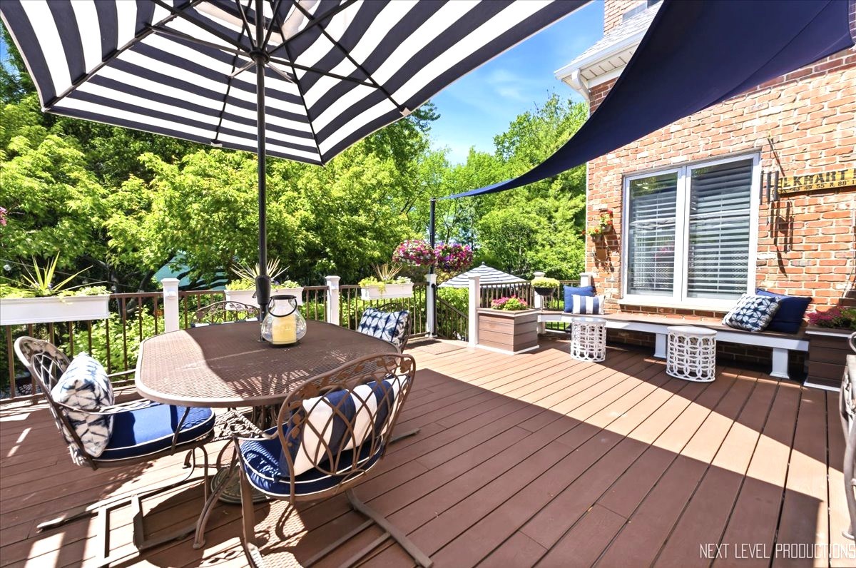 1914 North Ridge Avenue Arlington Heights, IL 60004 - Photo 40 of 50 a view of a patio with table and chairs with wooden floor and fence