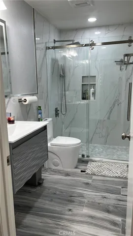 a bathroom with a sink toilet and shower