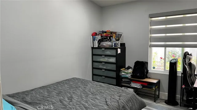 a bedroom with a bed and a desk