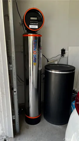 a close view of water heater and refrigerator in a kitchen